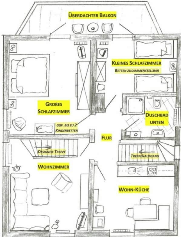 A hotel floor plan with a large bedroom, a smaller bedroom, a living room, a kitchen, a bathroom, and a balcony.