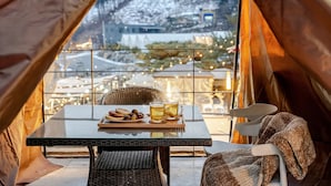 A cozy indoor setting with a table set for two, featuring cookies and a mug of tea, overlooking a snowy landscape through large windows. - Gapyeong Abek J Pool Villa (Gapyeong)