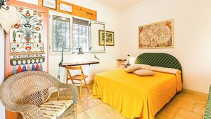 A room with a bed, a desk, a chair, and a large window. - Maria nel Casale Mastria by Casa di Marco (Neviano)
