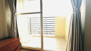 A room with a sliding glass door leading to a balcony with a metal railing. - 2-bedroom, 14th floor apartment in Nakkhu, Lalitpur nearby Medi-Citi hospital. (Lalitpur)