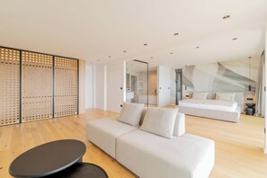 A modern living room with a sofa, a coffee table, and a sliding door. - Villa Reina (Makarska)