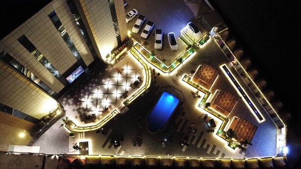 An aerial view of a hotel with a pool, outdoor seating area, and multiple floors with balconies. - Taj Al- Wajh hotel   (Al Wajh)