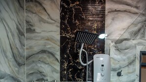 A bathroom with marble walls, a shower with a handheld showerhead, and a control panel. - Spacious Junior Suite near UN Nairobi, Cozy Stead Haven House (Nairobi)