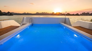 A swimming pool on a boat with a sunset view. - La SEN of the Bay Cruises  (Tuan Chau)