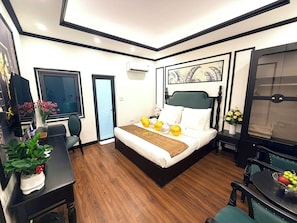 A hotel room with a bed, desk, chair, and a window. - GREEN LUXURY HOTEL (Hanoi)