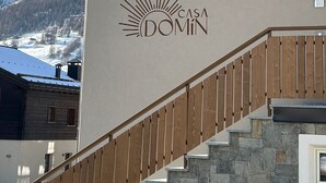 A building with a staircase, a window, and a logo that reads 'CASA DOMIN'. - Apartment '4 Bilocale Est' with Private Terrace (Livigno)