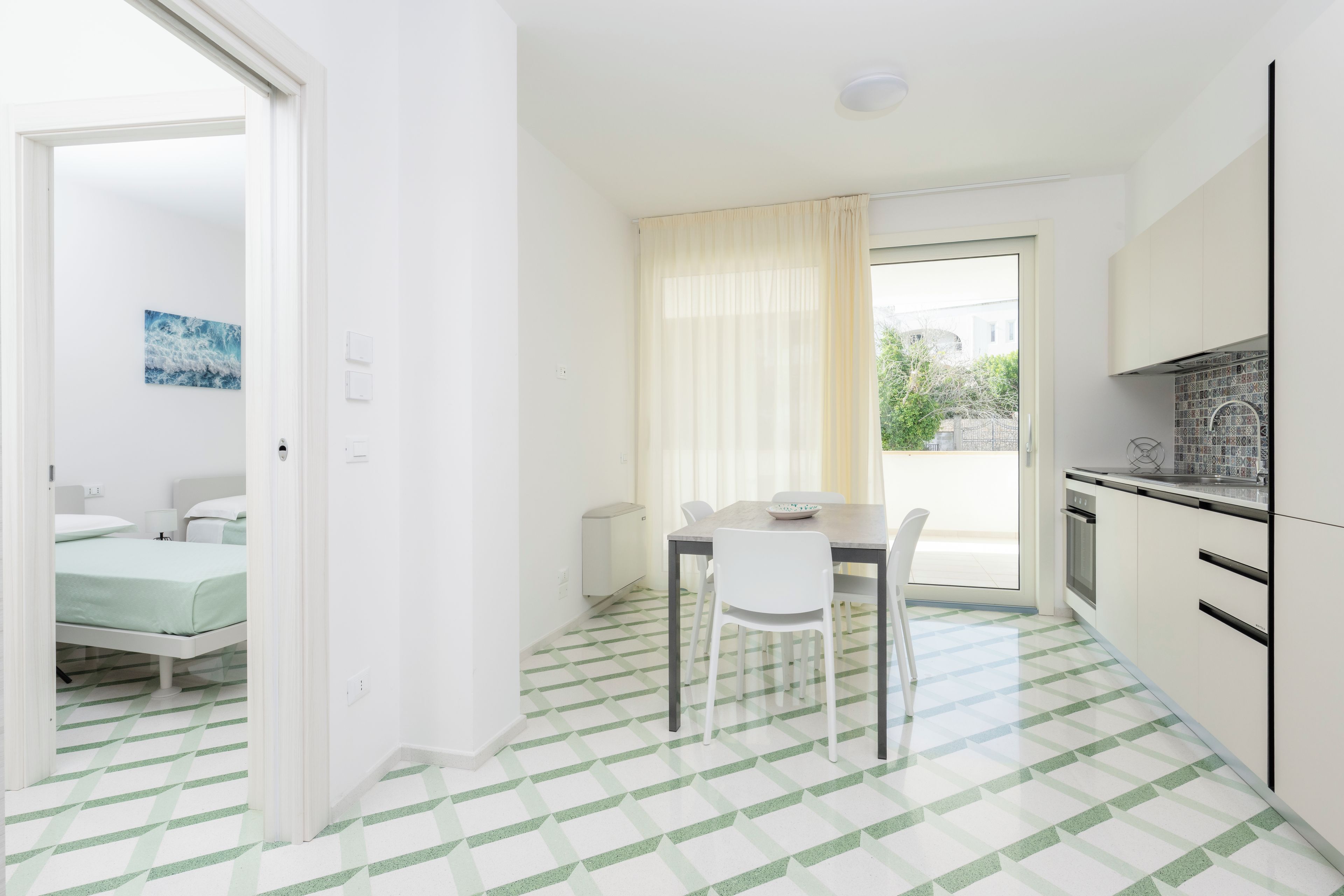 Een moderne keuken met een eetgedeelte, een kleine tafel en uitzicht op het omliggende landschap.
