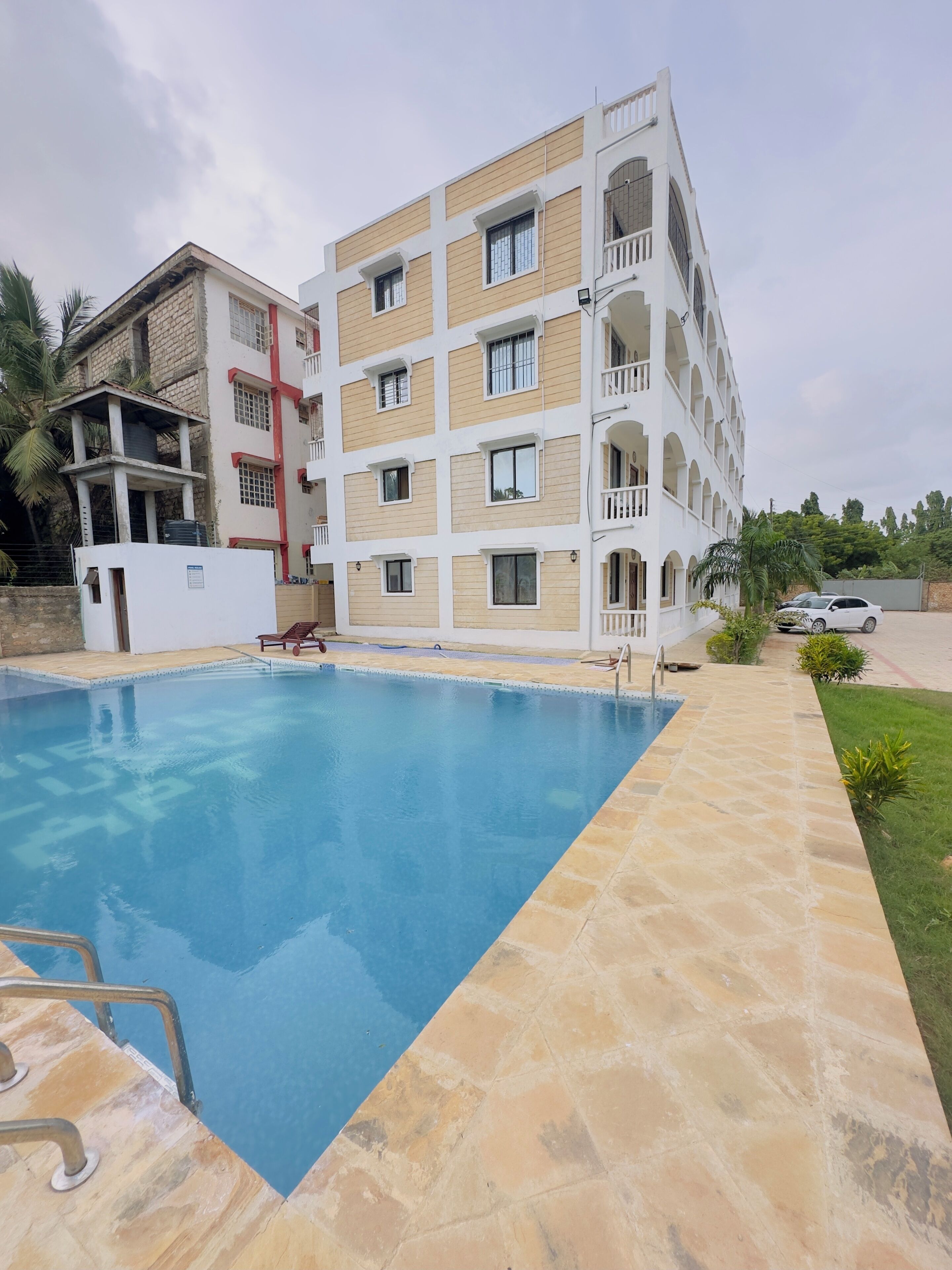 A multi-story building with a swimming pool.