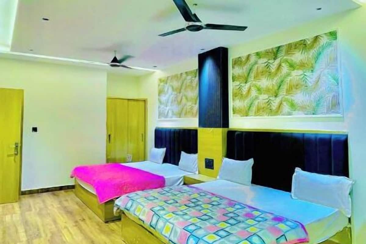 A modern bedroom with a large bed, a ceiling fan, and a mural on the wall.