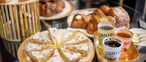 A variety of pastries and beverages on a table.