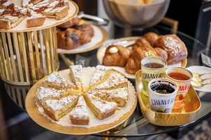 A variety of pastries and beverages on a table.