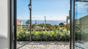 A balcony with a view of the sea, a pergola, and a patterned floor. - Authentic Madeira stay • Ocean View Apartments (Caniço)