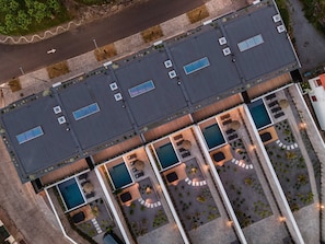 An aerial view of a hotel with multiple swimming pools, outdoor seating areas, and a parking lot. - Residence - Signature Villas (Lagoa)