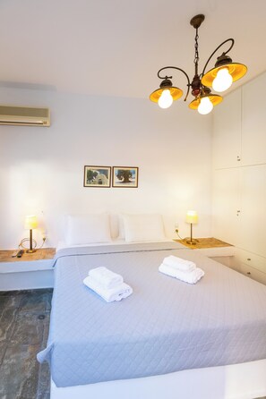 A hotel room with a bed, two bedside lamps, a ceiling light fixture, and two framed pictures on the wall. - The Bridge House, 4BR Home for 10 with Terrace, Spili Rethymno (Spili)