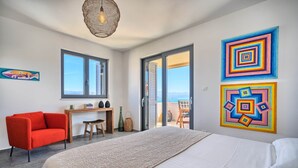 A modern bedroom with a large bed, a red chair, a desk, and a view of the outdoors. - One Bedroom Villa Ming (Slatine)