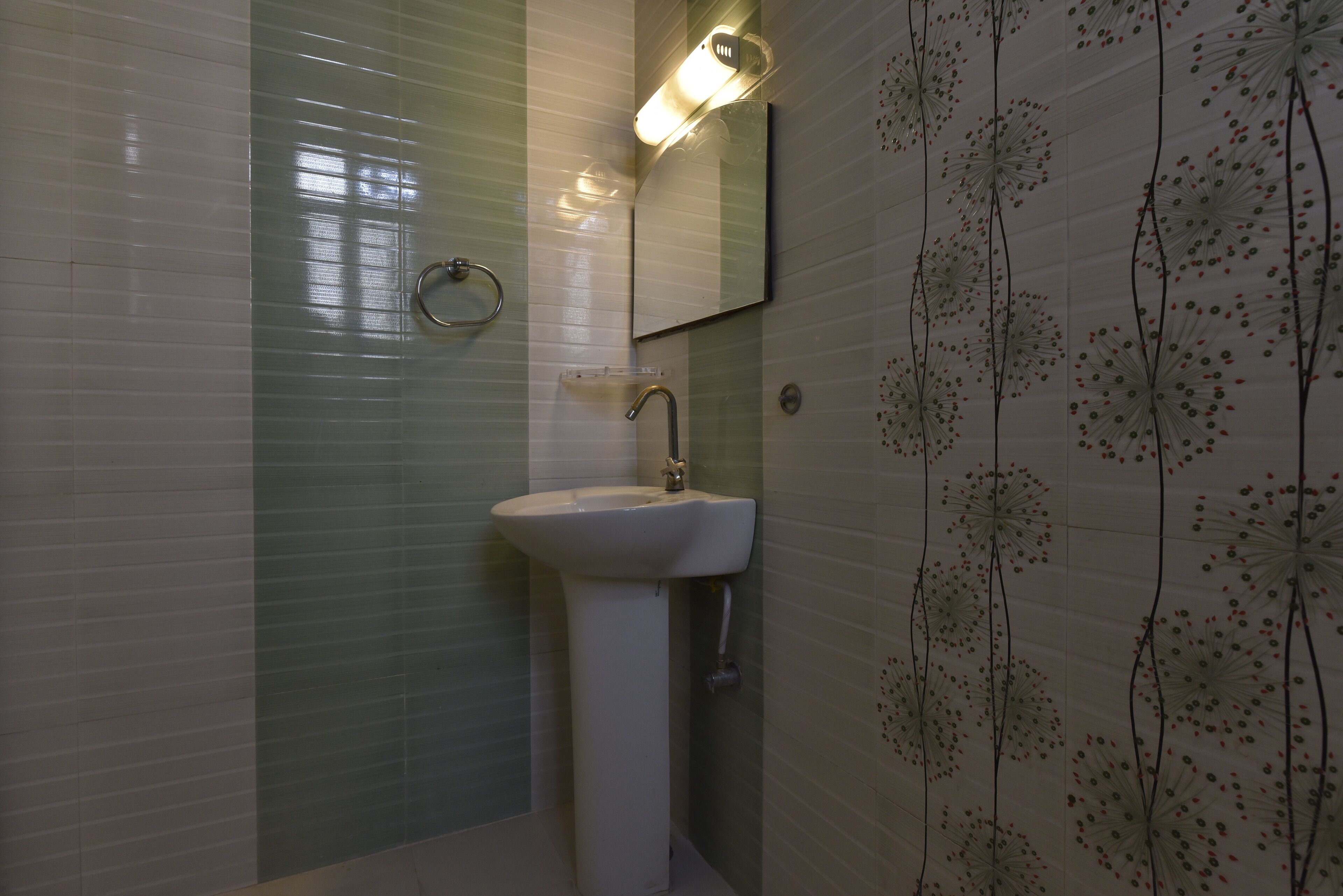A bathroom with a sink, mirror, and a towel rack.