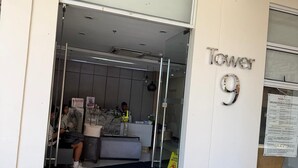 A hotel entrance with a reception desk, a sign reading "Tower 9", and a doormat with "Avida To" and "Sucat" text. - Trendy 1BR Avida Sucat – Pool & Airport Vicinity (Parañaque)