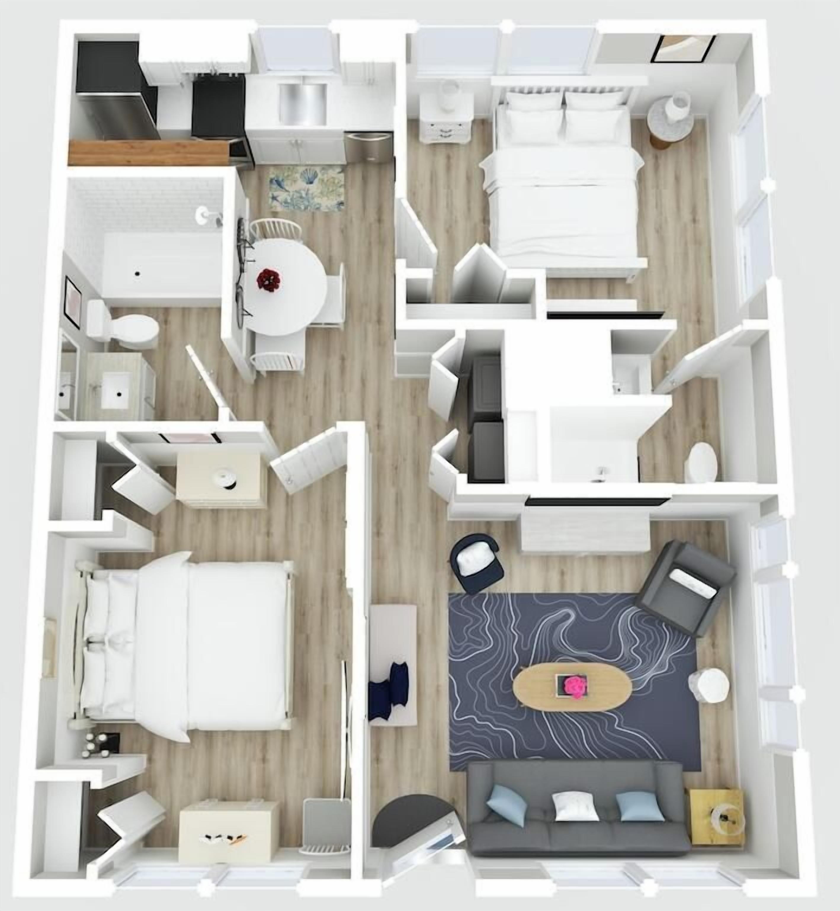 A hotel room layout with a bed, seating area, and a small kitchenette.