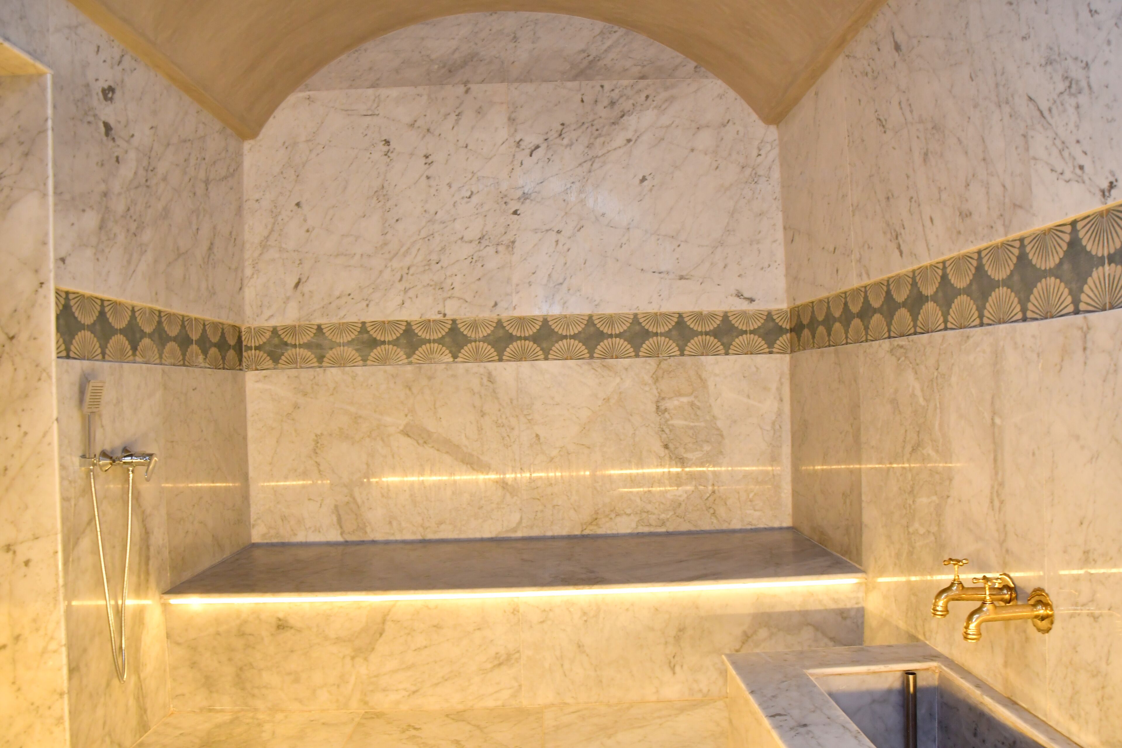 A marble bathroom with a shower, a bathtub, and a vanity.