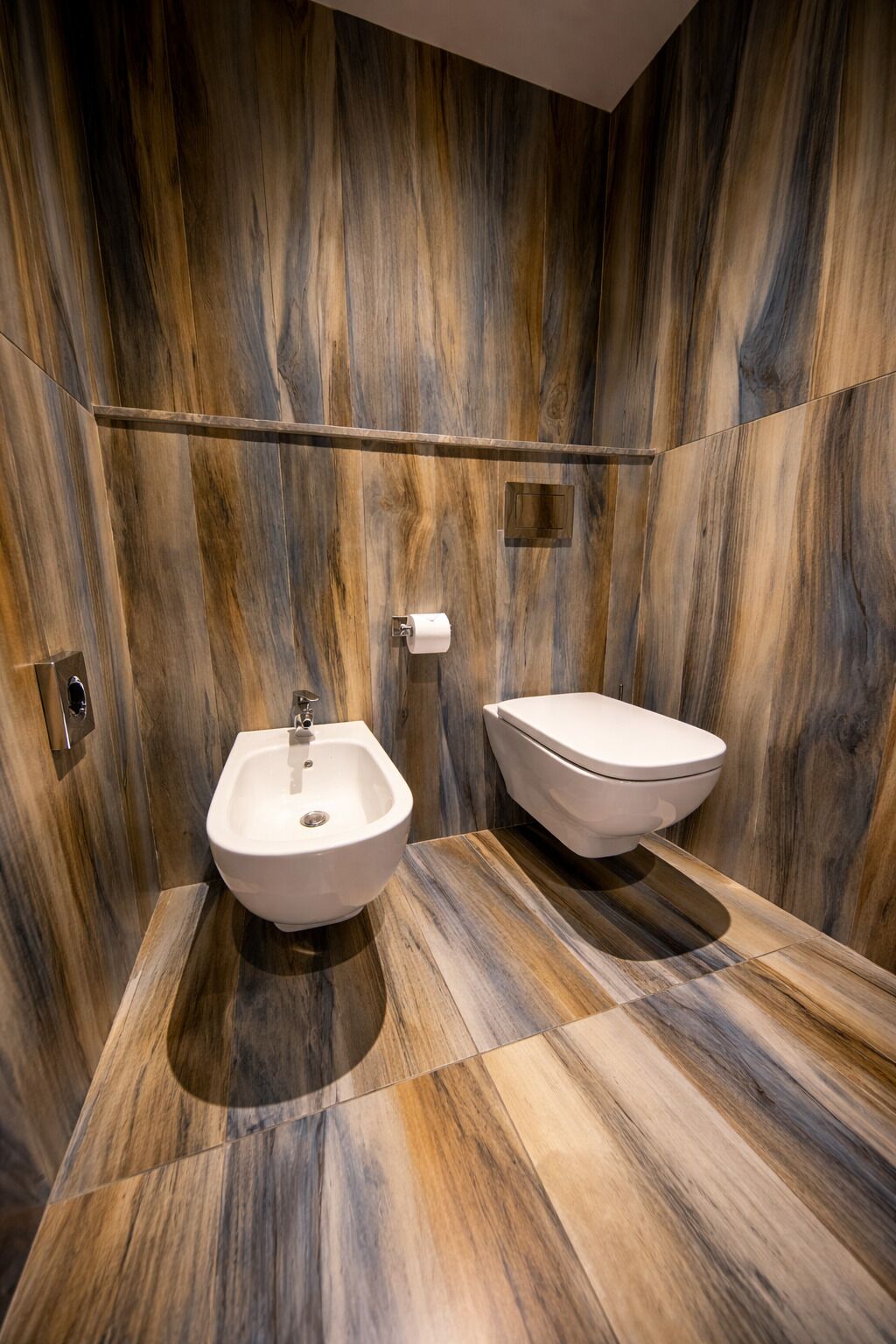 Un baño con bidé, inodoro y espejo.