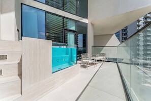 Terrace/patio - Bright 1BR Apartment Stay with Mini Pool, Near Community Parks - Binghatti Royale, Jumeirah Village Circle (Dubai)