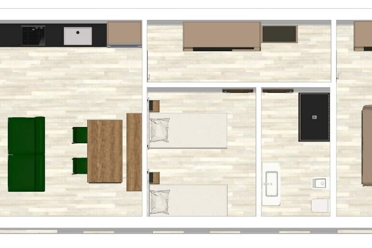 A floor plan of a hotel room with a kitchenette, a dining area, a bathroom, and a large bed.