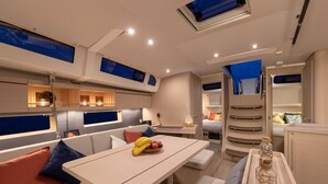 A modern interior with a dining area, seating, and a kitchen. - Sun-Kissed Sailing Adventure in Split-Dalmatia, Croatia (Marina)