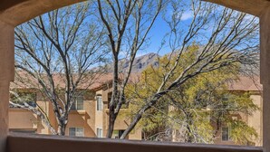 A view through an arched window of a building with a mountain in the background. - 2nd floor includes many personal touches and upgrades making a Perfect rental (Tucson)