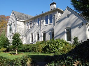 A large, two-story house with a symmetrical facade, multiple windows, and a well-maintained garden. - (SH) Rare Serviced 3-BR in Secluded and Peaceful Neighborhood (Atlanta)