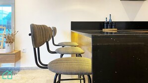 A modern kitchen with a black countertop, a built-in stove, and a hanging light fixture. - New 1 bd with garden and sea side at Marsa Cornich (Site archéologique de Carthage)