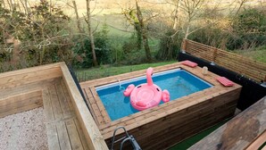 A wooden deck with a hot tub, surrounded by trees and a view of the countryside. - A Getaway in the Pyrenees: Views, Hot Tub, and Forest (Marseillan)