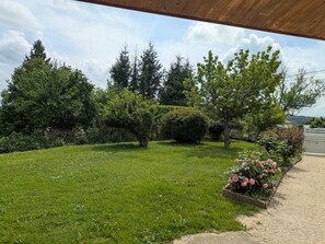 A well-maintained lawn with a gravel path leading to a gated entrance.