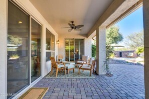 A covered patio with outdoor seating, a ceiling fan, and a view of the backyard. - AVAIL SEP 10 - OCT 5! Elegant Quail Creek Resort Home with Spool, Green Valley (Green Valley)