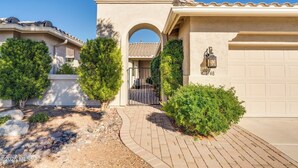 A residential house with a garage, a paved driveway, and well-maintained landscaping. - Elegant Quail Creek Resort Home with Spool, in Green Valley near Tucson (Green Valley)