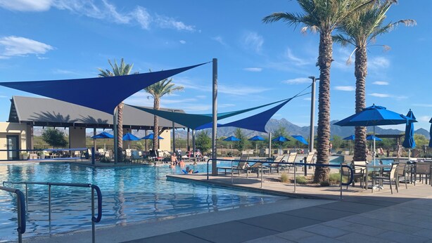 A pool area with lounge chairs, umbrellas, and palm trees. - Elegant Quail Creek Resort Home with Spool, in Green Valley near Tucson (Green Valley)