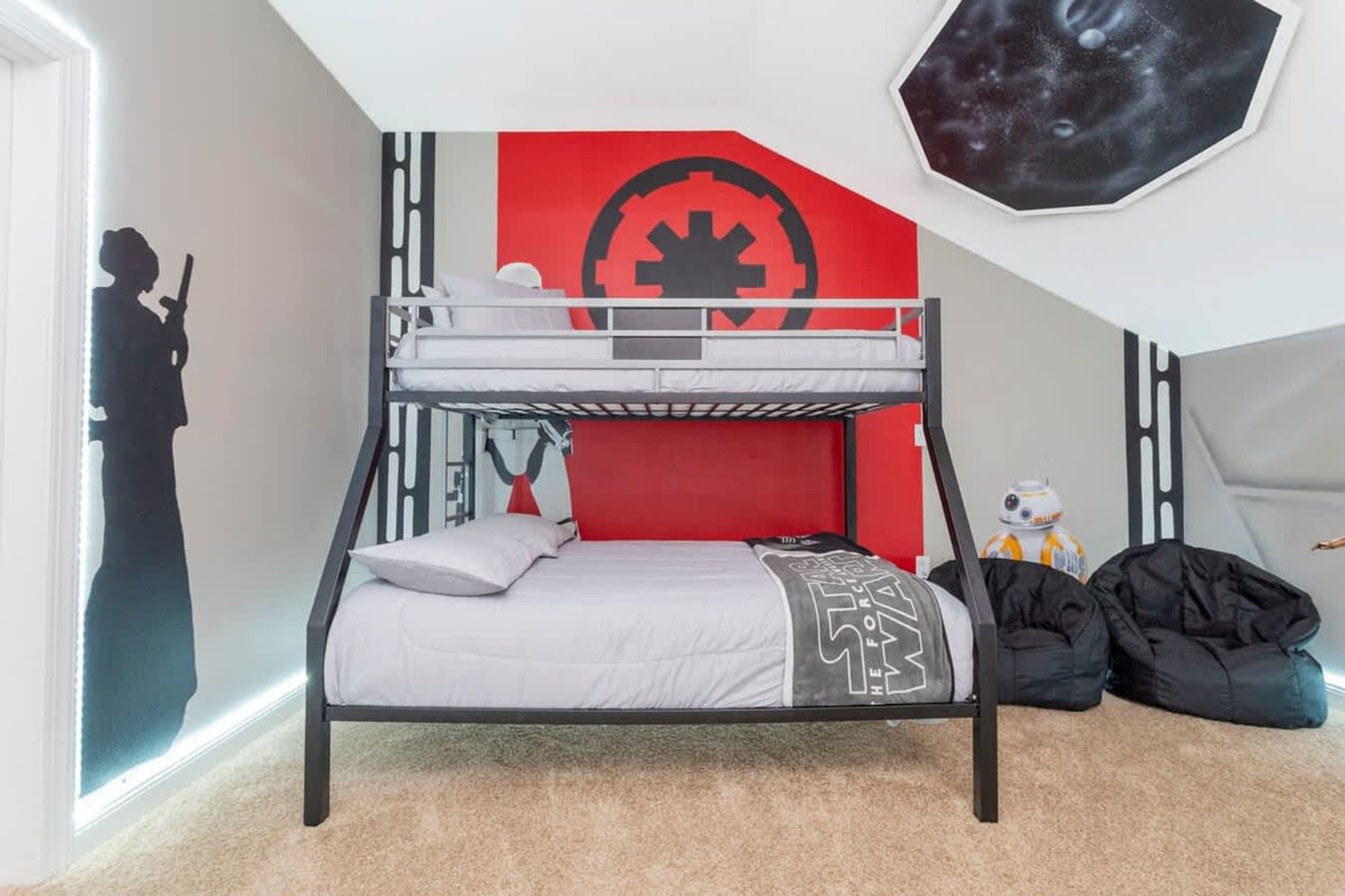 A bunk bed with a Star Wars-themed wall, a Star Wars figurine, and a Star Wars poster.