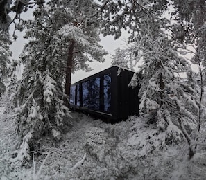A cabin surrounded by snow-covered trees. - Unique, Modern Cabin at Blefjell (Flesberg)