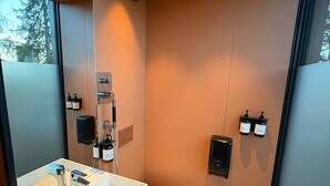 A modern bathroom with a white sink, a toilet, and a shower. - Unique, Modern Cabin at Blefjell (Flesberg)