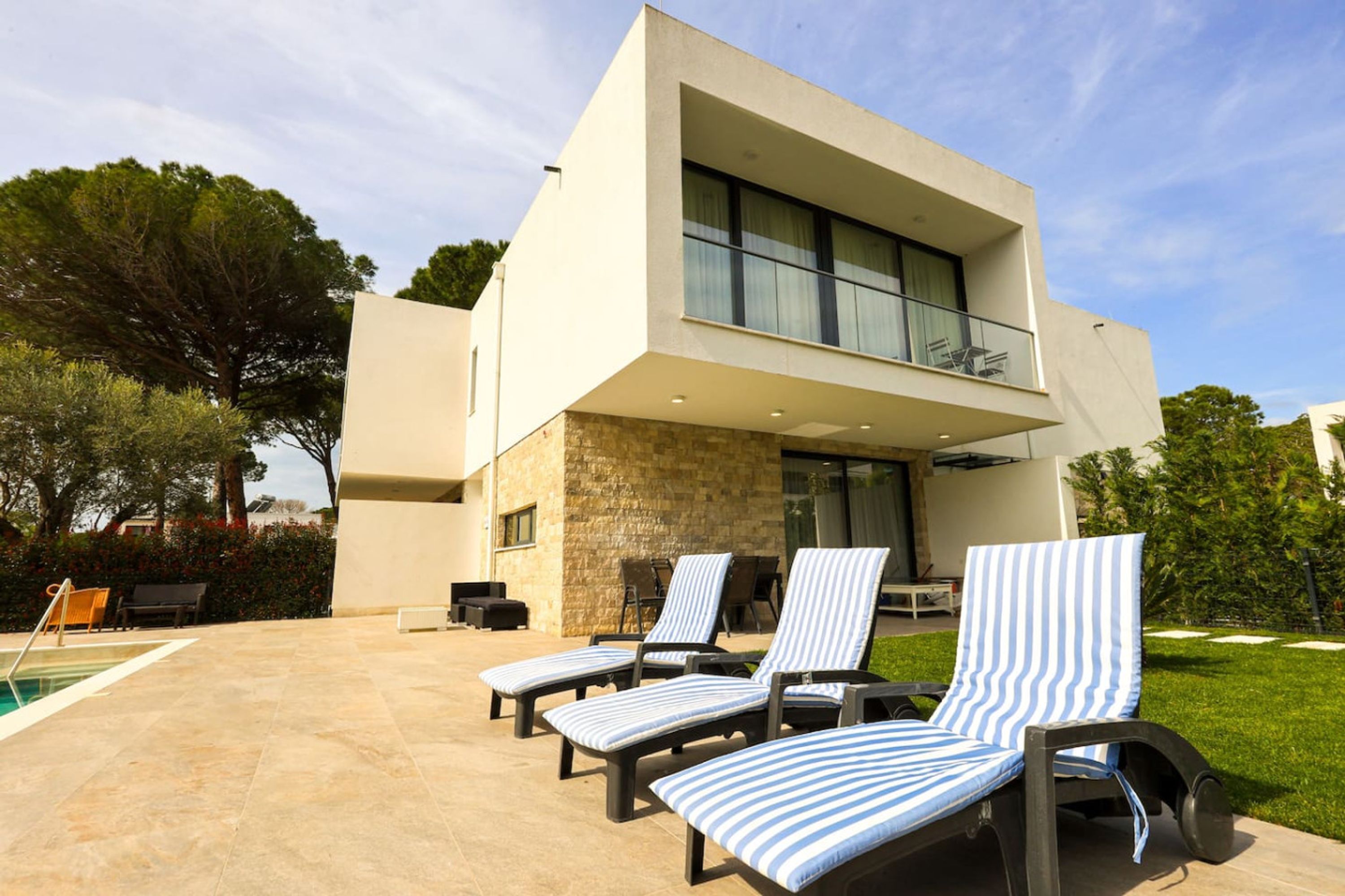 A modern two-story house with a pool area.