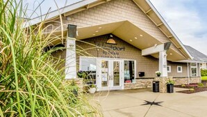 A hotel entrance with a sign reading "Westport by the Sea" and a visible entrance door. - NEW! Pool, BBQ, Beach Access, Hot Tub, Gym (SDreaming) (Westport)