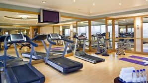 A gym with treadmills, elliptical machines, and weights. - Majestic Premier Hotel Bur Dubai (Dubai)