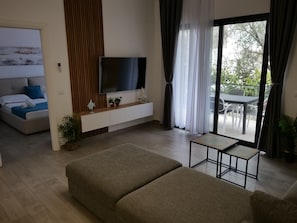 Apartamento conforto, sacada, vista para o jardim | Área de estar