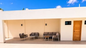 A swimming pool with clear blue water, surrounded by a white building with a wooden door and two windows. - Caribbean getaway,  minutes away from the airport,  Downtown Punta Cana, beaches and attractions. Whether you're here for adventure, romance, great family time or pure relaxation, this is the place where memories are made. (Punta Cana)