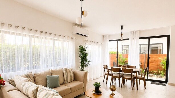 A spacious living room with a sofa, coffee table, and dining area with chairs. - Caribbean getaway,  minutes away from the airport,  Downtown Punta Cana, beaches and attractions. Whether you're here for adventure, romance, great family time or pure relaxation, this is the place where memories are made. (Punta Cana)