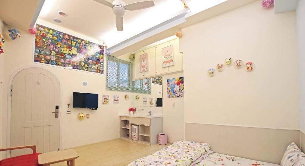 A child's bedroom with a bed, desk, and wardrobe.