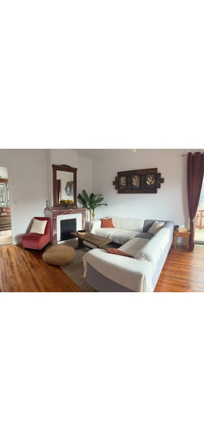 A living room with a sofa, armchair, and a small table. - The blue house (Courniou)