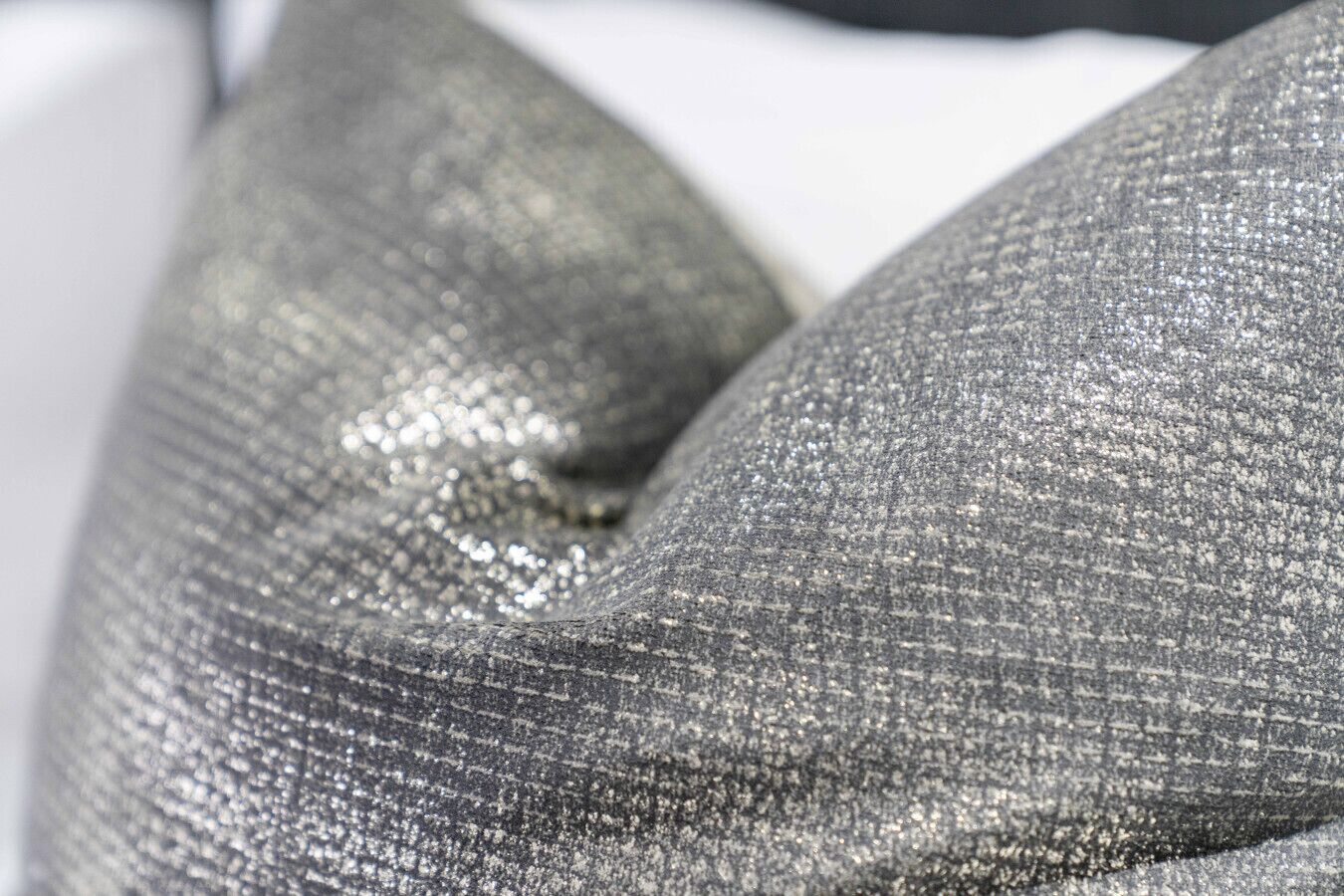 A close-up of a metallic fabric with a textured surface.
