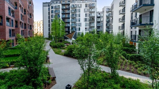 A modern apartment complex with multiple buildings, a central pedestrian pathway, and surrounding greenery. - Malila Apartments Cracow Rakowicka 254 (Kraków)