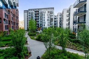 A modern apartment complex with multiple buildings, a central pedestrian pathway, and surrounding greenery. - Malila Apartments Cracow Rakowicka 254 (Kraków)