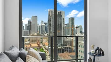 Apartment, City View | Living area | 50-inch Smart TV with cable channels